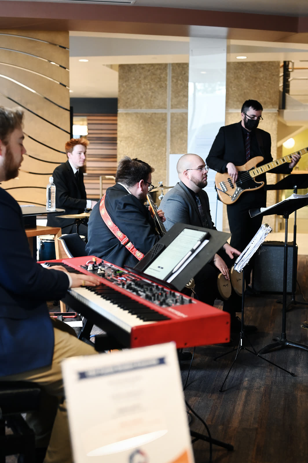 Band performing beside an event program