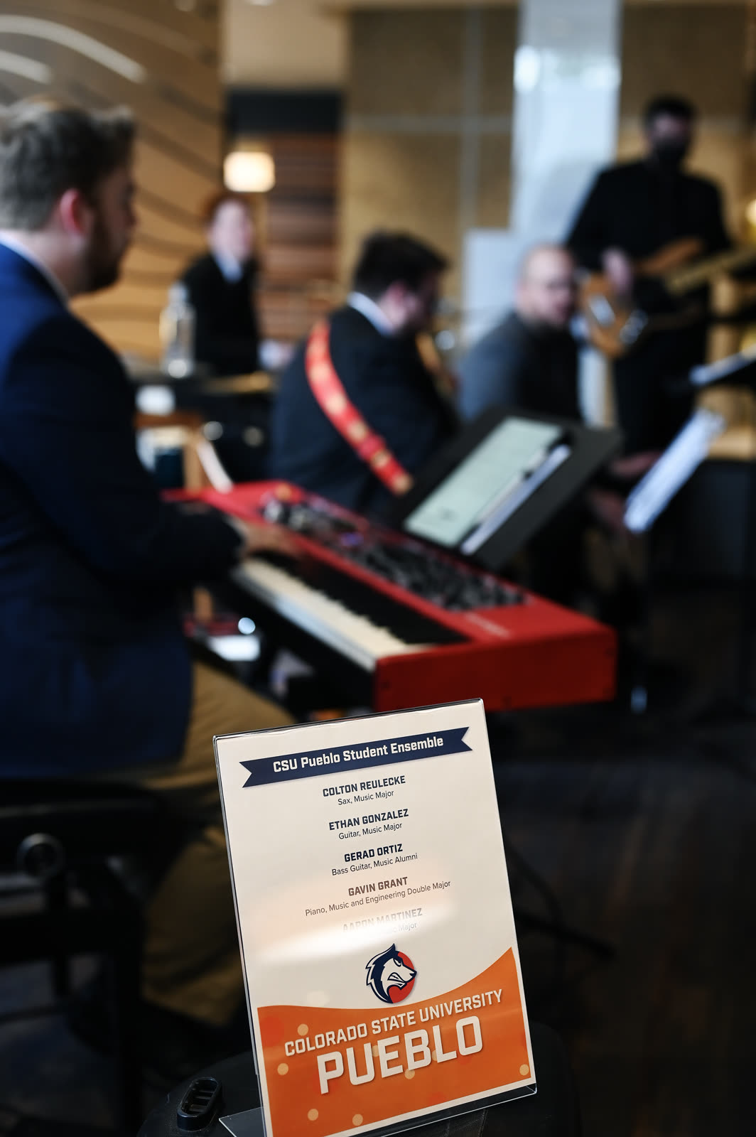 Keyboard player and ensemble during a live event