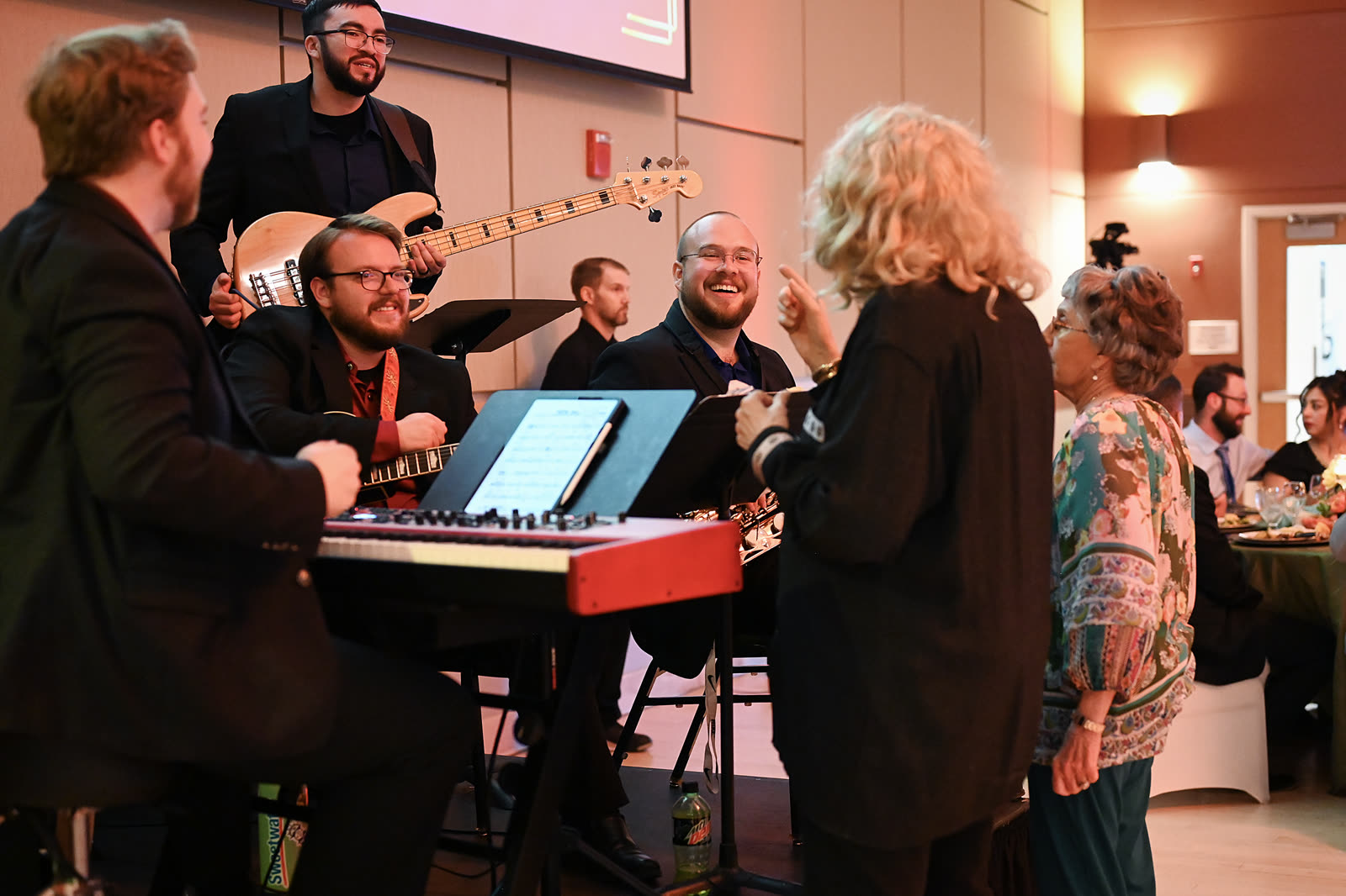 Band members entertaining guests at a reception